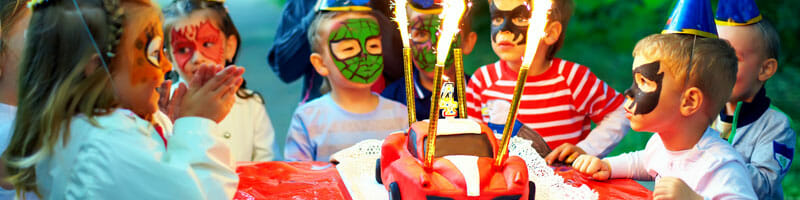 A group of kids around a birthday cake